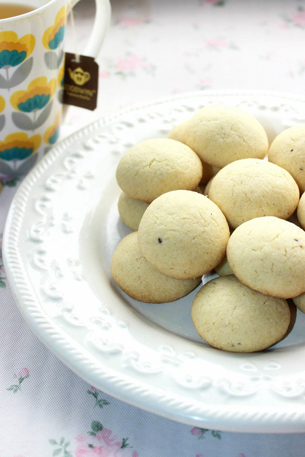 plate full of semolina cardamom cookies - just 6 ingredients, crisp, melt in mouth fragrant cookies, ready in 30 mins are a perfect tea time snack!