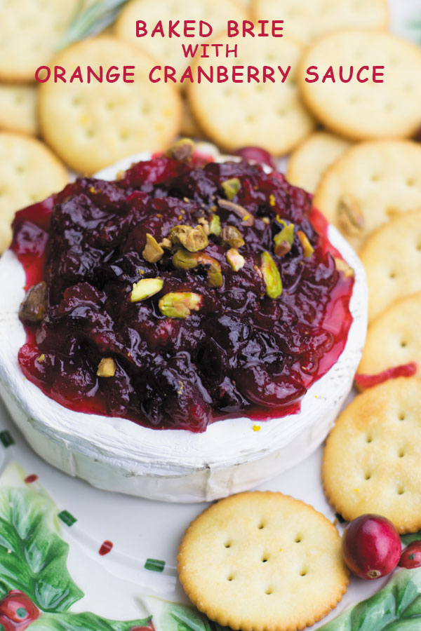 Baked brie with orange cranberry sauce - Delicious & simple holiday appetizer. Baked brie served with a simple yet beautifully flavored orange cranberry sauce! I can't stop eating this.