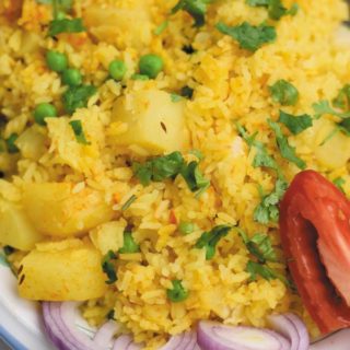 slow cooker spiced vegetable rice - delicious eaten plain or served as a side, this one pot meal comes together in slow cooker! Spiced rice with peas and potatoes makes for a cozy dinner!