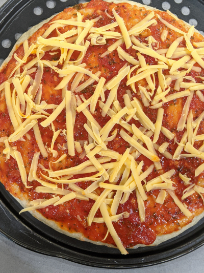 homemade thick crispy bottom pan pizza cheese over sauce