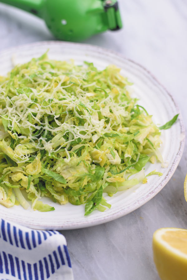 simple easy brussel sprouts salad - a REALLY simple yet ADDICTING crunchy brussel sprouts salad with tangy lemon juice vinaigrette and gruyere!