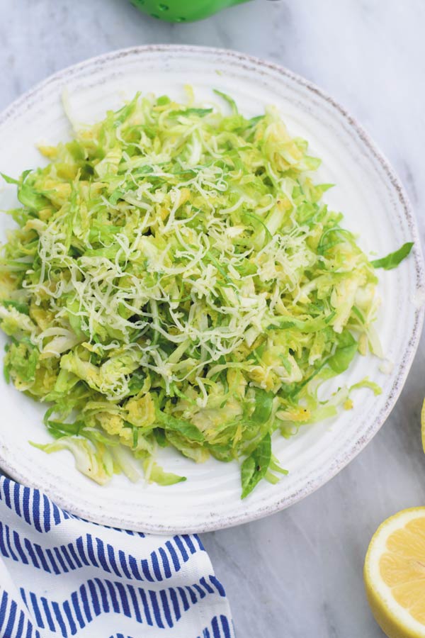 simple easy brussel sprouts salad - a REALLY simple yet ADDICTING crunchy brussel sprouts salad with tangy lemon juice vinaigrette and gruyere!