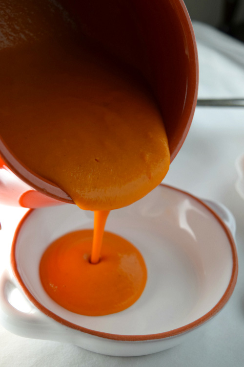 Pouring Creamy Tomato Soup into a Bowl