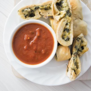 cheesy spinach calzones on a plate 1