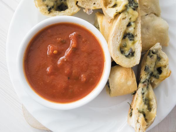 cheesy spinach calzones on a plate 1