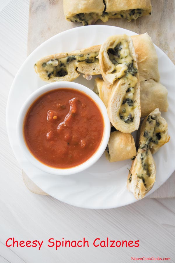 cheesy spinach calzones on a plate 1