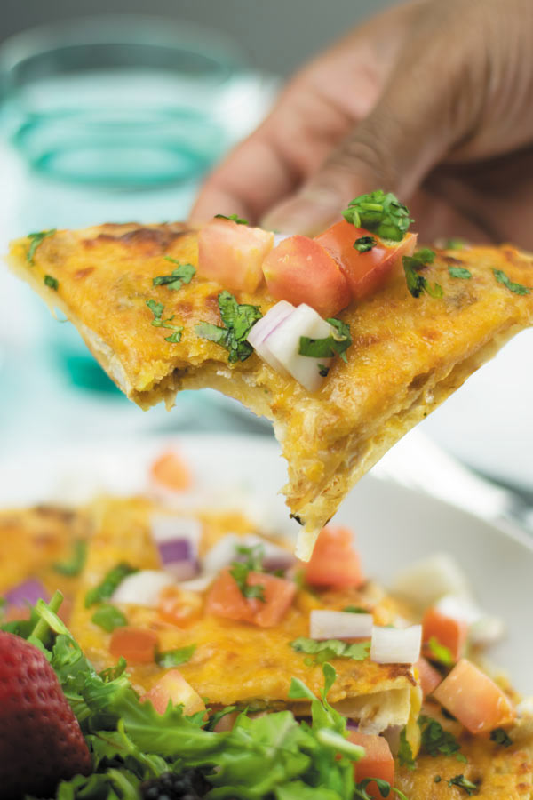 bite from cheesy piri piri chicken quesadilla pizza