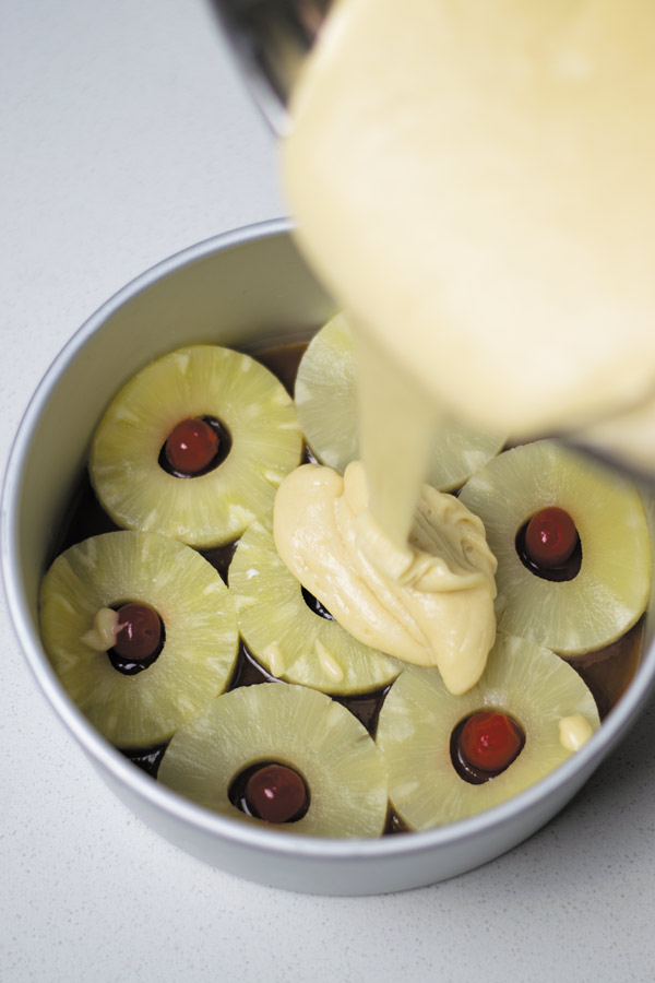 pouring batter for pineapple upside down cake