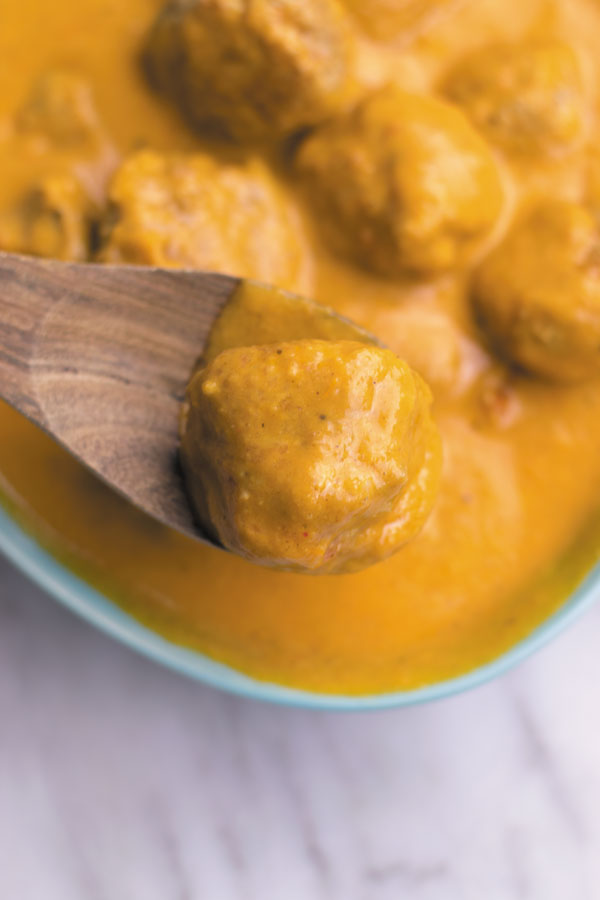 bite from butter chicken meatballs