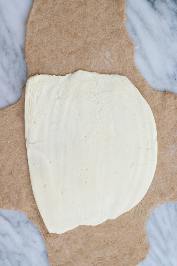 placing butter on dough in whole wheat croissant