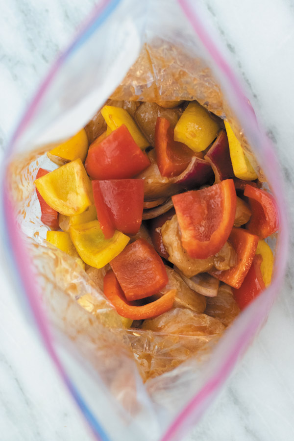 vegetables and chicken marinating for bbq grilled chicken skewers 