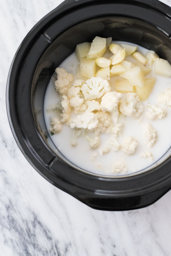 Crockpot skinny potato soup - Comforting CROCKPOT soup, lightened version of POTATO SOUP, mixed with cauliflower which even picky eater's can't tell! A perfect make ahead weeknight meal!