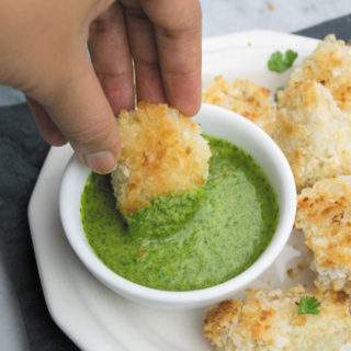 Crunchy Baked Coconut Chicken Bites - Crunchy baked coconut chicken, slightly on the sweeter side served with a spicy cilantro dipping sauce. So good!