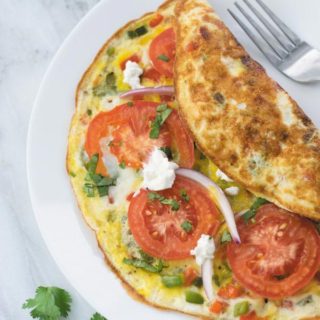 15 mins Veggie Omelette Recipe - a simple out of fridge meal, perfect for breakfast/lunch or dinner. This is one meal I cook when in no mood of cooking! An easy, filling & healthy omelette.