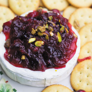 Baked brie with orange cranberry sauce - Delicious & simple holiday appetizer. Baked brie served with a simple yet beautifully flavored orange cranberry sauce! I can't stop eating this.