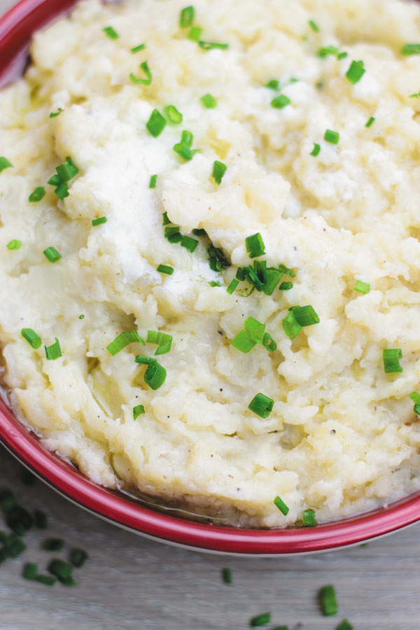 Slow Cooker Garlic Mashed Potatoes - make holiday time easier by making everyone's favorite mashed potatoes in SLOW COOKER! No boiling needed! Just throw everything in slow cooker and just stir once done!