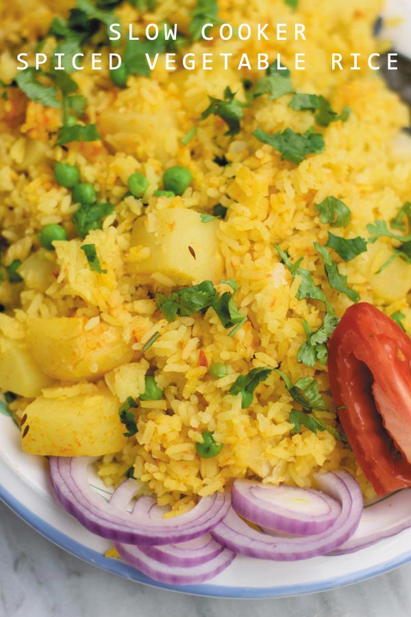 slow cooker spiced vegetable rice - delicious eaten plain or served as a side, this one pot meal comes together in slow cooker! Spiced rice with peas and potatoes makes for a cozy dinner!