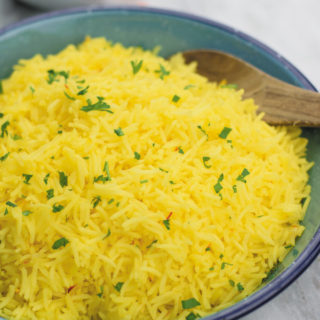 Easy Yellow Saffron Rice - Better Than your favorite Mediterranean restaurant, this SIMPLE yellow saffron rice is full of flavor & GREAT as a side!