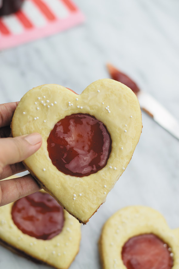 Coconut & jam heart cookies - Coconut cookies with strawberry jam sandwiched in between. So good, just few ingredients and ready in under an hour!