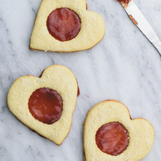 Coconut & jam heart cookies - Coconut cookies with strawberry jam sandwiched in between. Perfect valentines day treat or anytime snack!