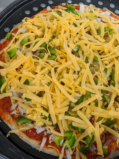 homemade thick crispy bottom pan pizza ready for baking