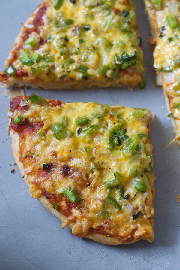 homemade thick crispy bottom pan pizza sliced ready for eating